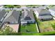 Aerial view of a home with solar panels, a backyard, and an outdoor patio area at 2145 Rush Bay Way, Orlando, FL 32824