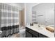 Bathroom featuring a shower-tub combo, modern toilet, and vanity with black hardware at 2145 Rush Bay Way, Orlando, FL 32824