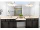 Bathroom featuring double sink vanity, large mirror, and modern fixtures, creating a bright and functional space at 2145 Rush Bay Way, Orlando, FL 32824