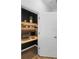 A bright home office setup with wood floors and built-in shelves, seen through a white doorway at 2145 Rush Bay Way, Orlando, FL 32824