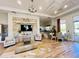 Stylish lounge area showcasing a stone accent wall, modern furniture, and a glimpse of the kitchen at 224 Meghan Cir, Deland, FL 32724
