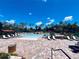 Resort-style pool area with ample lounge chairs and lush landscaping, perfect for relaxation and recreation at 224 Meghan Cir, Deland, FL 32724