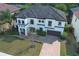 Aerial view of a luxurious two-story home with a tile roof, beautiful landscaping, and brick driveway at 2351 Kelbrook Ct, Oviedo, FL 32765