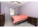 Bedroom with lavender walls, carpet, ceiling fan, and window with blind at 2351 Kelbrook Ct, Oviedo, FL 32765