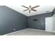 A modern bedroom with gray walls, a ceiling fan, and a TV mount, offering a comfortable and tech-ready space at 2351 Kelbrook Ct, Oviedo, FL 32765