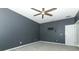 A bedroom with gray walls, ceiling fan, carpet, and a door leading to a closet or bathroom at 2351 Kelbrook Ct, Oviedo, FL 32765