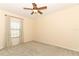 Bright bedroom features neutral walls, carpet flooring, a ceiling fan, and a window for natural light at 2351 Kelbrook Ct, Oviedo, FL 32765