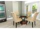 Cozy breakfast nook with glass table and chairs adjacent to the kitchen at 2351 Kelbrook Ct, Oviedo, FL 32765