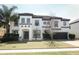 Charming two-story home with manicured lawn, tile roof, and neutral color palette at 2351 Kelbrook Ct, Oviedo, FL 32765