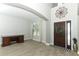 Inviting foyer featuring soaring ceilings, desk space, and beautiful dark wood front door at 2351 Kelbrook Ct, Oviedo, FL 32765