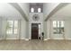 Elegant foyer featuring a soaring ceiling, wood floors, and decorative wall art at 2351 Kelbrook Ct, Oviedo, FL 32765