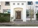 Elegant home featuring a stylish wood front door framed by a white archway and brick pathway at 2351 Kelbrook Ct, Oviedo, FL 32765