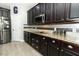 Kitchen with stainless appliances, stone countertops, and dark wood cabinets at 2351 Kelbrook Ct, Oviedo, FL 32765