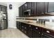 Modern kitchen with dark cabinets, granite countertops, and stainless steel appliances at 2351 Kelbrook Ct, Oviedo, FL 32765