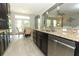 Bright kitchen featuring stainless steel appliances, granite countertops, and access to the dining room at 2351 Kelbrook Ct, Oviedo, FL 32765