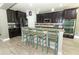 Gourmet kitchen featuring granite countertops, stainless steel appliances, and breakfast bar at 2351 Kelbrook Ct, Oviedo, FL 32765