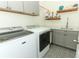 Well-lit laundry room featuring modern appliances, decorative tile flooring, and ample storage at 2351 Kelbrook Ct, Oviedo, FL 32765