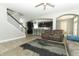 Living room view showcasing staircase, seating, kitchen bar and lots of natural light at 2351 Kelbrook Ct, Oviedo, FL 32765