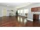 Spacious living room with hardwood floors, a bar, natural light from large windows, and Christmas decor at 2351 Kelbrook Ct, Oviedo, FL 32765