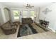 Open-concept living room featuring neutral decor, lots of natural light, and stylish furnishings for comfortable living at 2351 Kelbrook Ct, Oviedo, FL 32765
