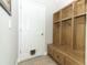 Functional mudroom featuring a built-in wooden bench, hooks, and storage, coupled with a convenient pet door at 2351 Kelbrook Ct, Oviedo, FL 32765