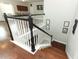 View of a staircase with dark wood steps and white spindles leading down to the main floor at 2351 Kelbrook Ct, Oviedo, FL 32765