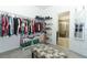 Spacious walk-in closet with hanging racks and a decorative storage chest at 2351 Kelbrook Ct, Oviedo, FL 32765