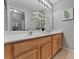 A bathroom featuring a light wood double sink vanity and a large mirror with decorative lighting at 275 Clydesdale Cir, Sanford, FL 32773