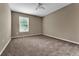 A neutral-colored bedroom is illuminated by natural light and features a ceiling fan and plush carpeting at 275 Clydesdale Cir, Sanford, FL 32773