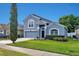 Charming two-story home with a well-maintained lawn and attached two-car garage at 275 Clydesdale Cir, Sanford, FL 32773