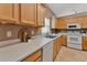 Well-lit kitchen includes wood cabinetry, stainless steel sink, and light countertops at 275 Clydesdale Cir, Sanford, FL 32773