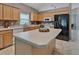 Spacious kitchen boasts wooden cabinets, a central island, and modern stainless steel appliances at 275 Clydesdale Cir, Sanford, FL 32773