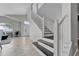 Bright foyer featuring tile flooring, a staircase with dark treads and a view of the front door at 275 Clydesdale Cir, Sanford, FL 32773