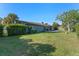 Large backyard with mature trees and a covered patio at 2805 Bongart Rd, Winter Park, FL 32792