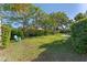 Grassy backyard surrounded by lush green foliage with lawn furniture at 2805 Bongart Rd, Winter Park, FL 32792