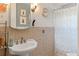 Bathroom with tiled wall and patterned shower curtain at 2805 Bongart Rd, Winter Park, FL 32792