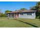 Single story home with brick accents, symmetrical windows, and a lush green lawn on a sunny day at 2805 Bongart Rd, Winter Park, FL 32792