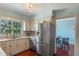 Functional kitchen with stainless steel appliances, white cabinets, and a view to the dining area at 2805 Bongart Rd, Winter Park, FL 32792