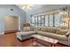 Relaxing living room featuring hardwood floors, a sectional sofa, and natural light through shuttered windows at 2805 Bongart Rd, Winter Park, FL 32792