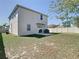 Exterior of home with a backyard featuring a well-maintained lawn, a patio area, and privacy fencing at 2820 Black Birch Dr, Ocoee, FL 34761