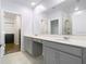 Bright bathroom with double vanity, undermount sinks, and walk-in closet access at 2820 Black Birch Dr, Ocoee, FL 34761