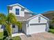 Beautiful two-story home boasts a two-car garage, brick paved driveway, and professional landscaping at 2820 Black Birch Dr, Ocoee, FL 34761