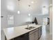 This open kitchen showcases a breakfast bar, modern faucet, and stainless steel dishwasher for easy meal prep at 2820 Black Birch Dr, Ocoee, FL 34761