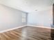 Well-lit living room featuring wood floors, neutral walls, and large window at 2820 Black Birch Dr, Ocoee, FL 34761