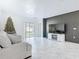 Bright living room features a dark accent wall, tile flooring, and sliding glass doors for natural light at 2820 Black Birch Dr, Ocoee, FL 34761
