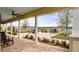 Outdoor patio area offering seating, ceiling fans, and scenic views of a lake, perfect for relaxation and entertaining at 2820 Black Birch Dr, Ocoee, FL 34761