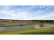 Scenic view of a pond with trees and a grassy shoreline at 2820 Black Birch Dr, Ocoee, FL 34761