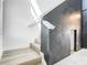 Modern staircase with wood steps and a dark accent wall, offering a stylish transition between levels at 2820 Black Birch Dr, Ocoee, FL 34761