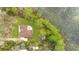 Aerial view showcases a meticulously kept lawn, charming patio and lush greenery of the property at 30041 Redoak Ave, Eustis, FL 32736