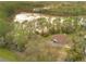 Aerial view showing the property's location next to a serene lake at 30041 Redoak Ave, Eustis, FL 32736